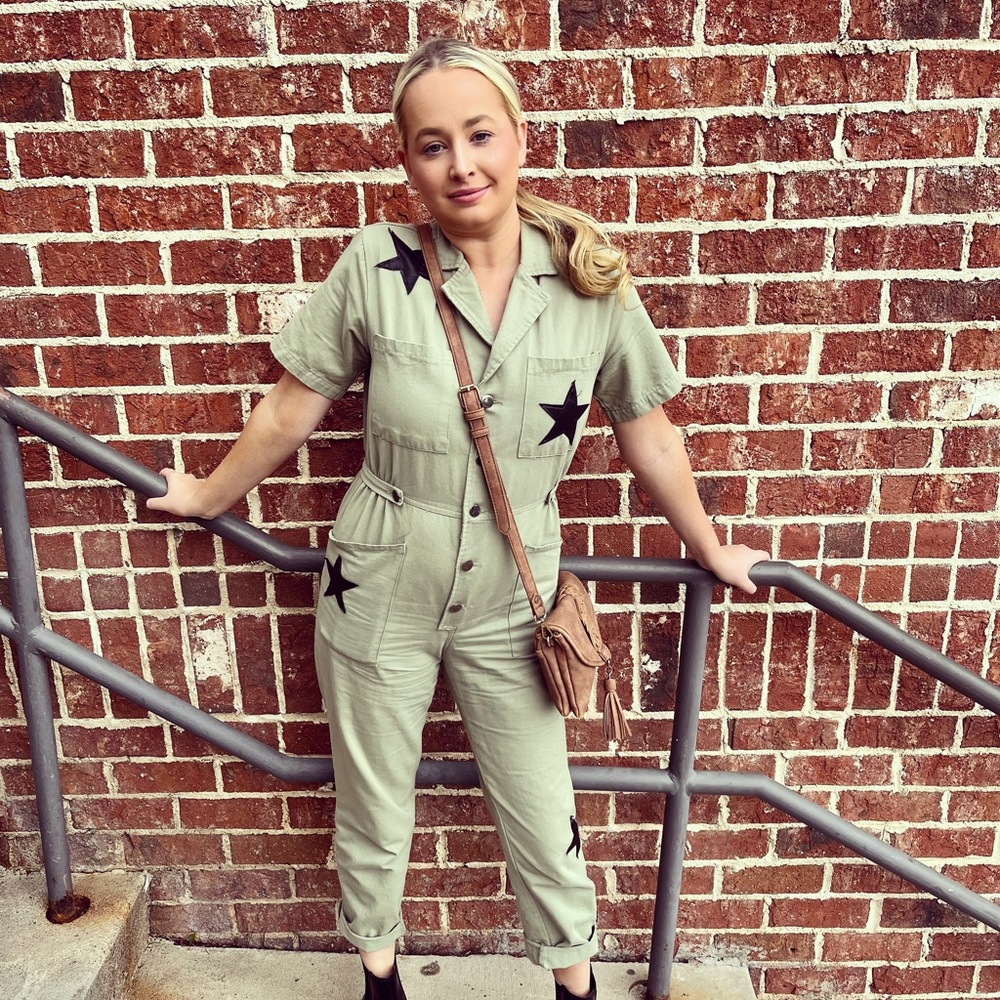 Green jumpsuit with black leather stars. Size small